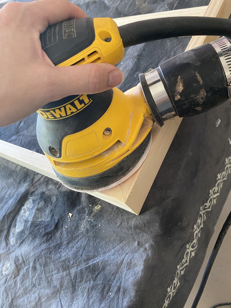 sanding a canvas frame