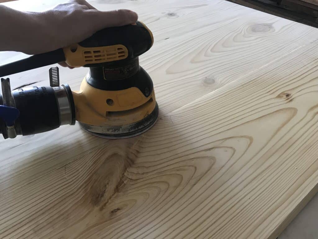 sanding a rustic square coffee table