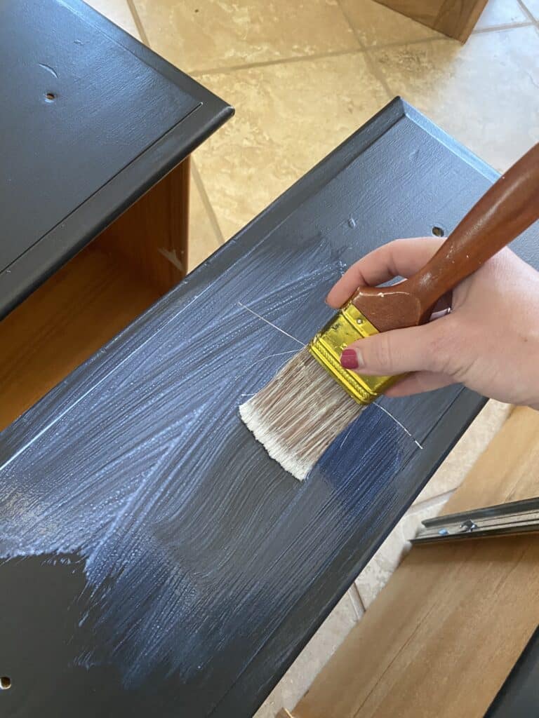 applying the finish to furniture painted black