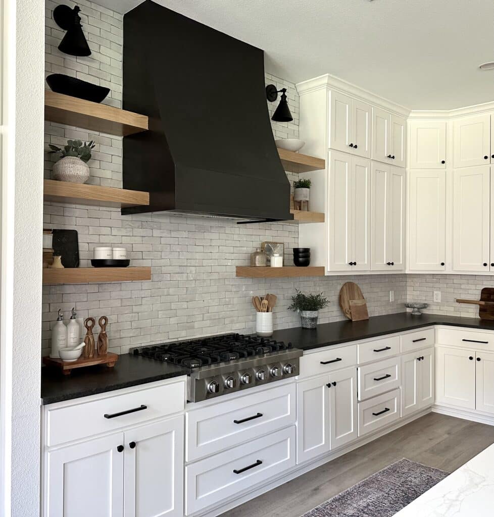 black and white kitchen with black range hood