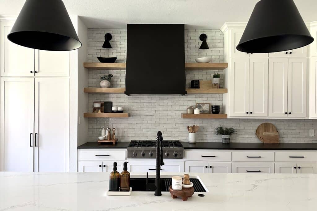 finished black range hood over gas range