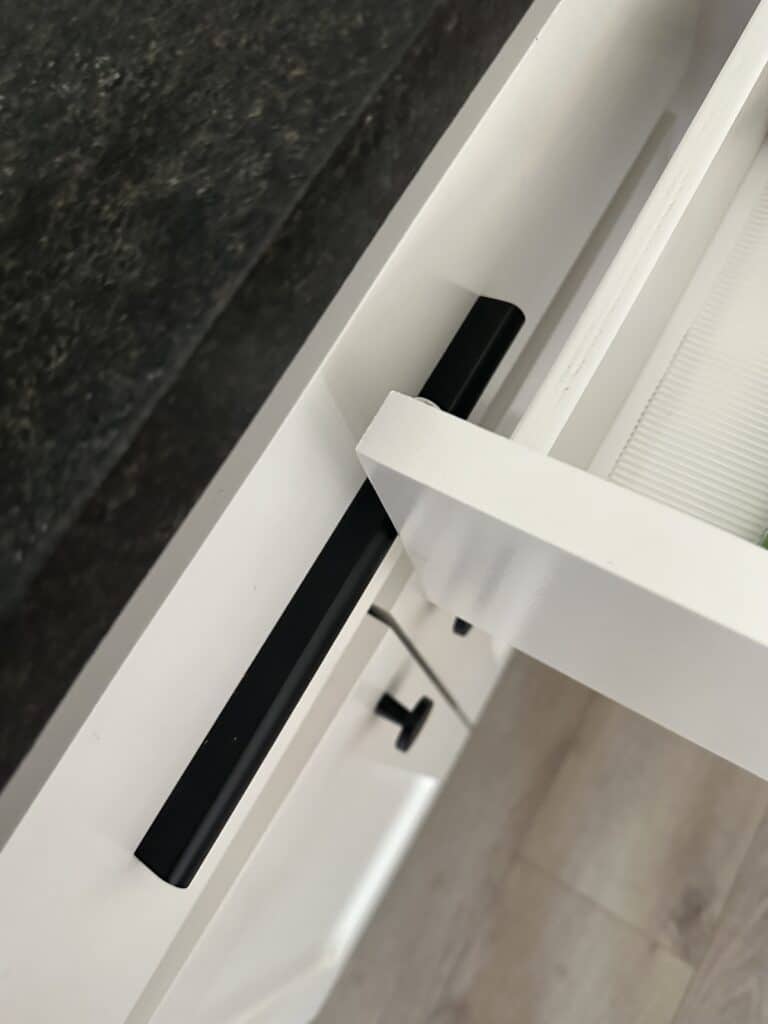 low profile matte black bar pulls on white shaker style kitchen cabinets