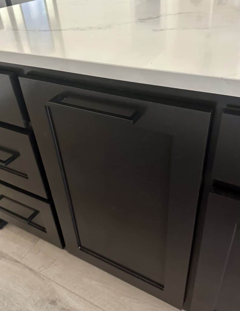 matte black bar pulls on black shaker style trash pull out