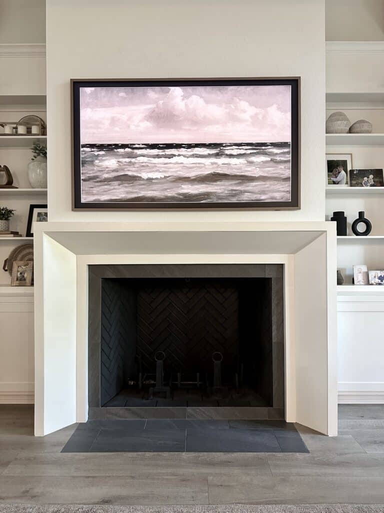 white fireplace surround with tv over fireplace