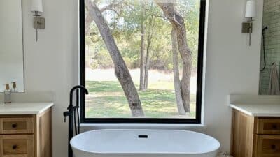 free standing tub between two vanities big window
