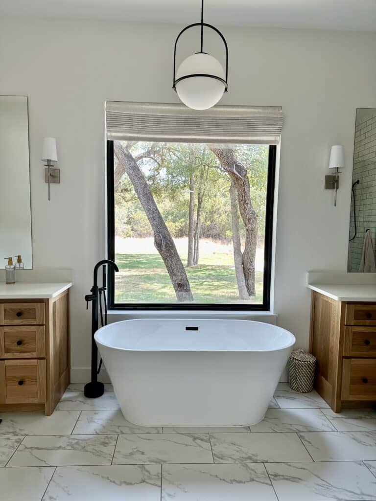 free standing tub between two vanities big window