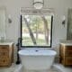 free standing tub between two vanities big window